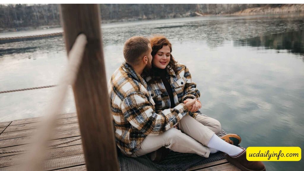 Couple-sitting-beside-a-peaceful-mountain-lake