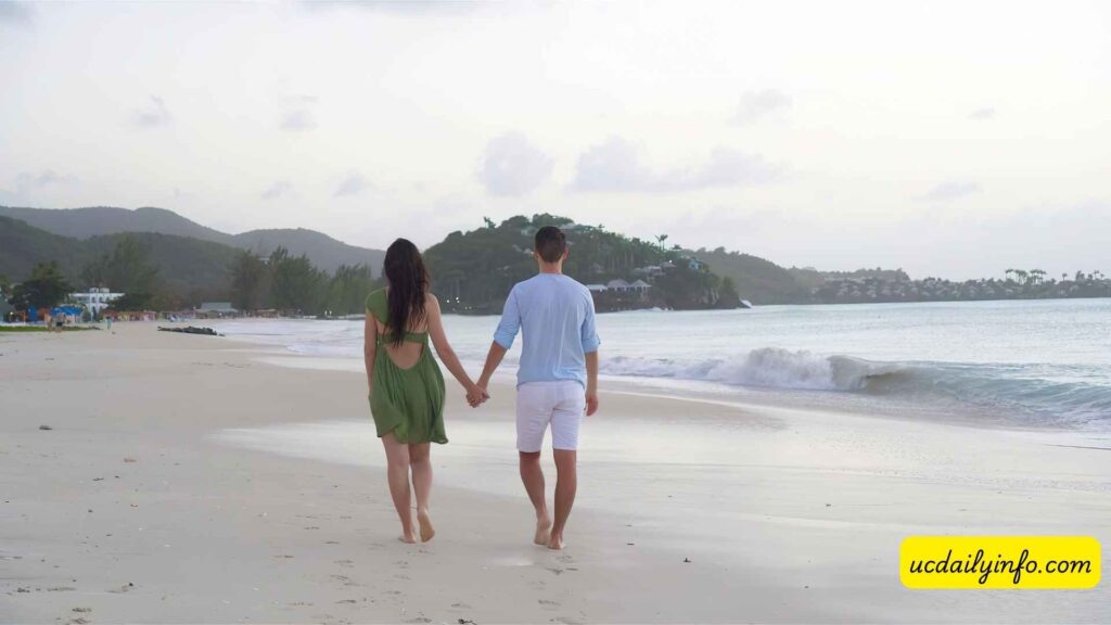 Couple-walking-hand-in-hand-along-the-beach