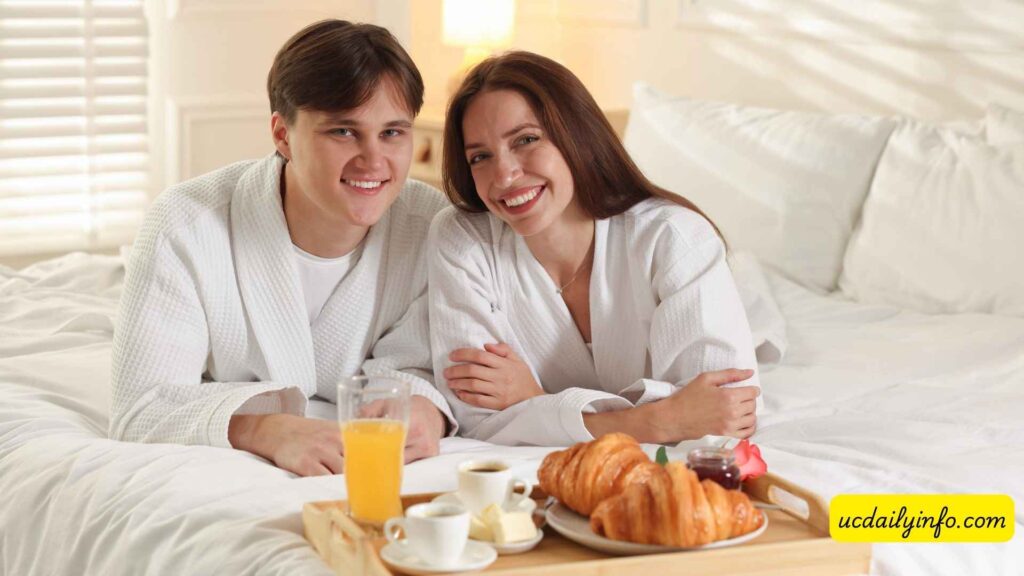 Couple-enjoying-breakfast-on-a-hotel-balcony-overlooking-the-ocean-25-Romantic-Couple-Vacation-Ideas