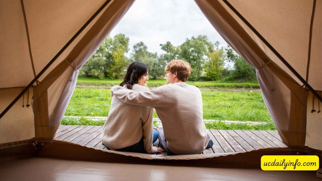 Couple-relaxing-outside-a-glamping-tent-under-the-stars